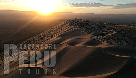 Sunrise over dune of Cerro Blanco